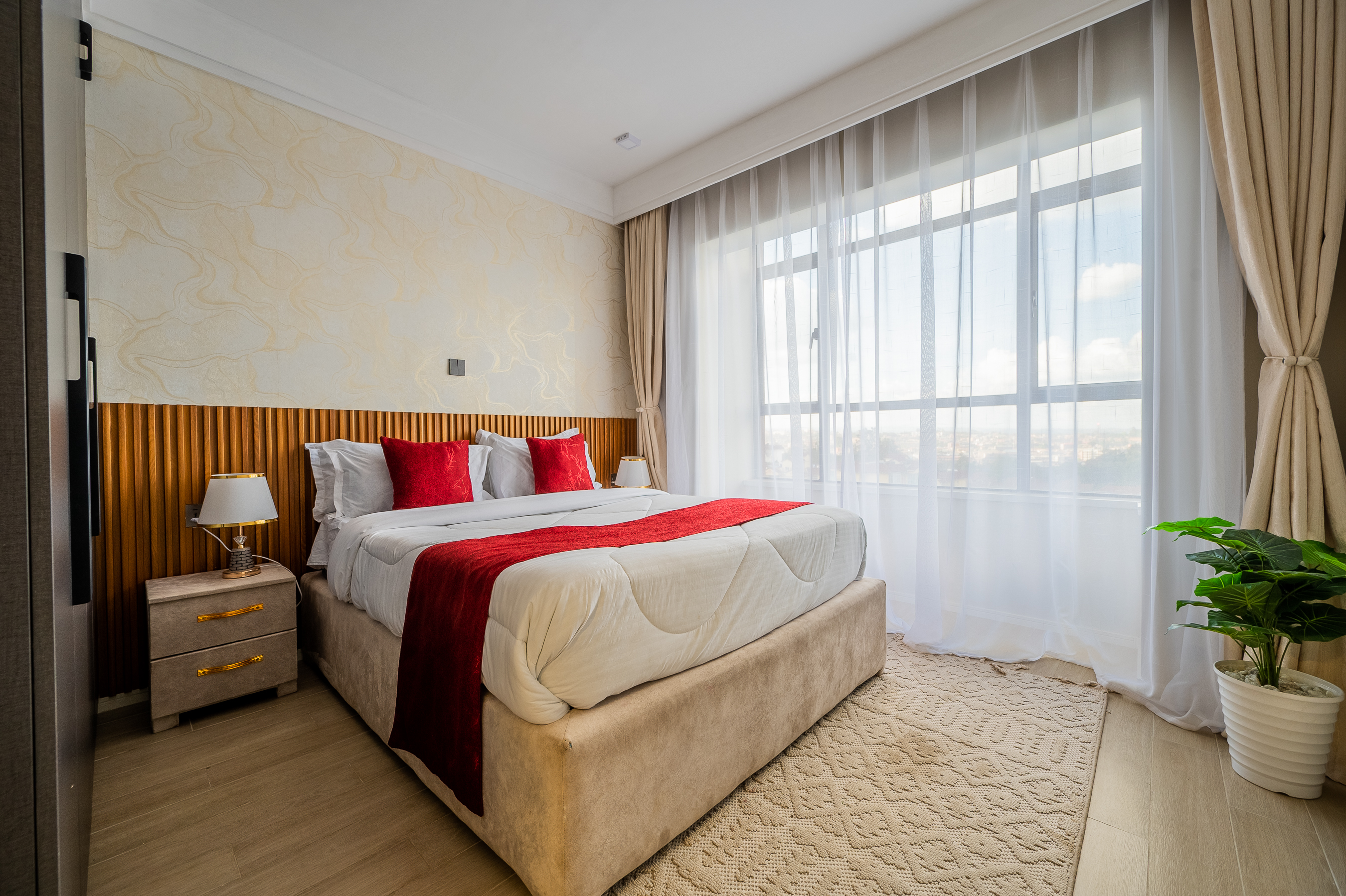 Master bedroom with double bed, wardrobe and soft natural lighting