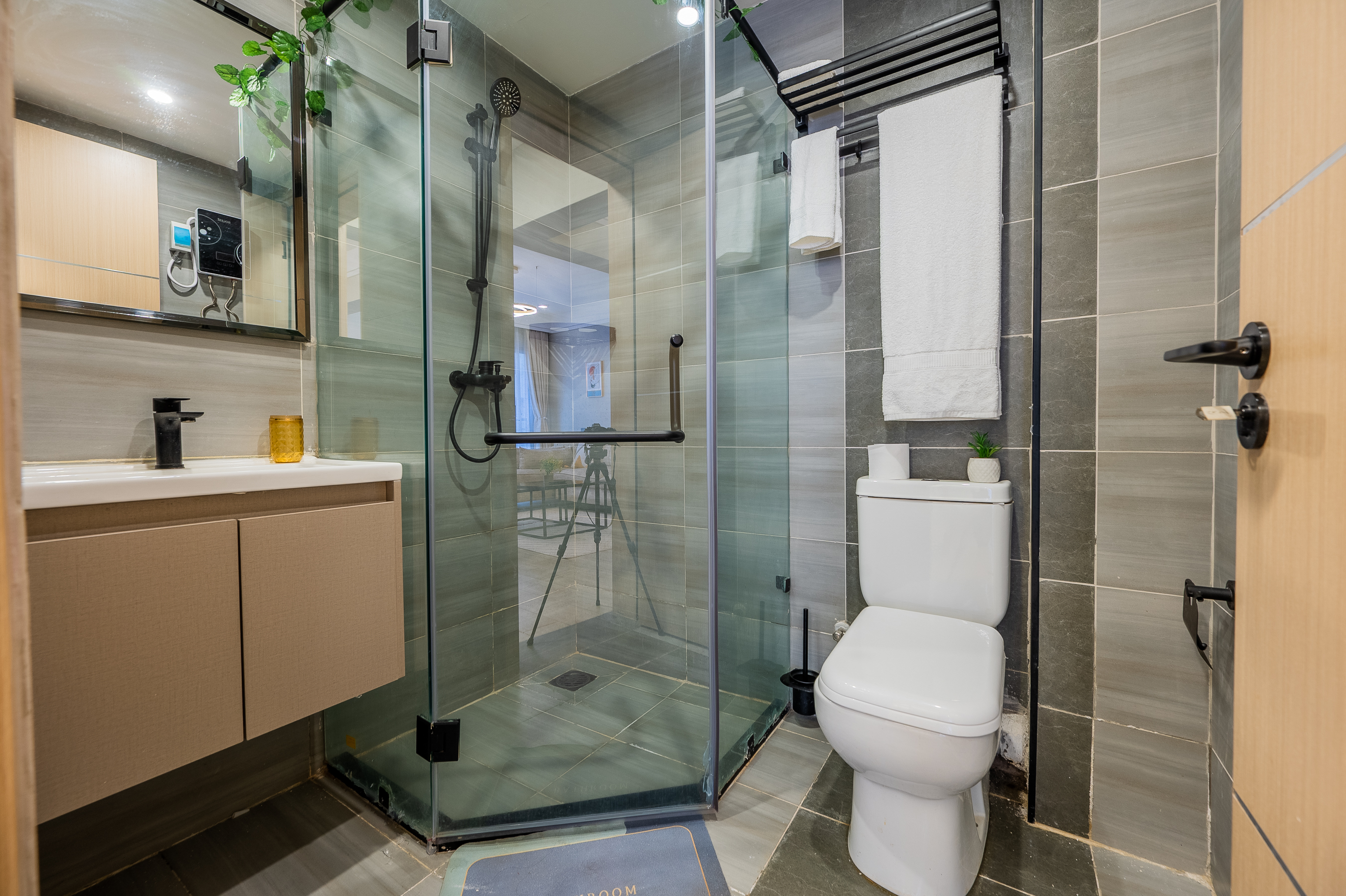 Modern bathroom with shower, vanity and tiled finishes