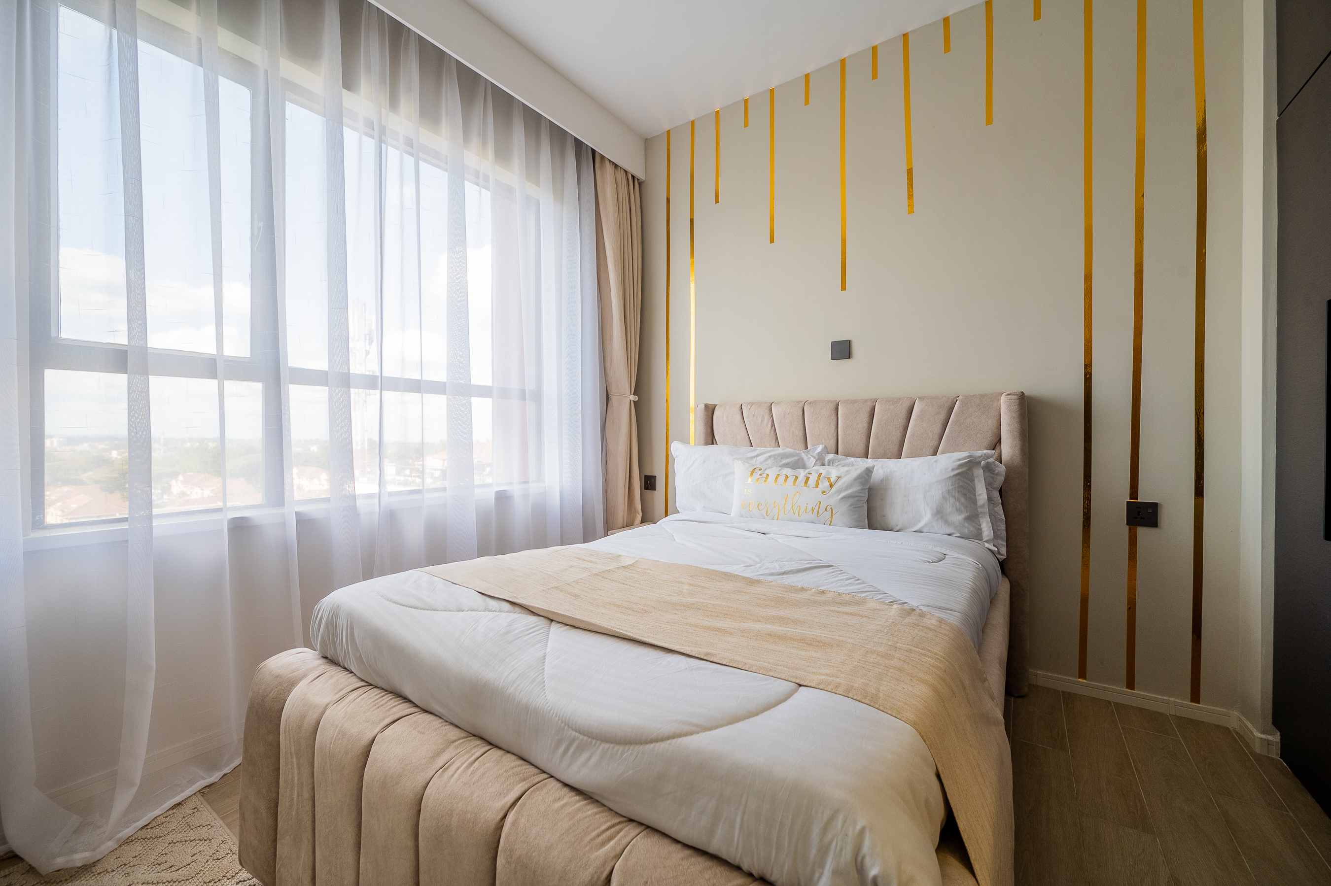 Furnished bedroom with bed, bedside tables and wardrobe storage