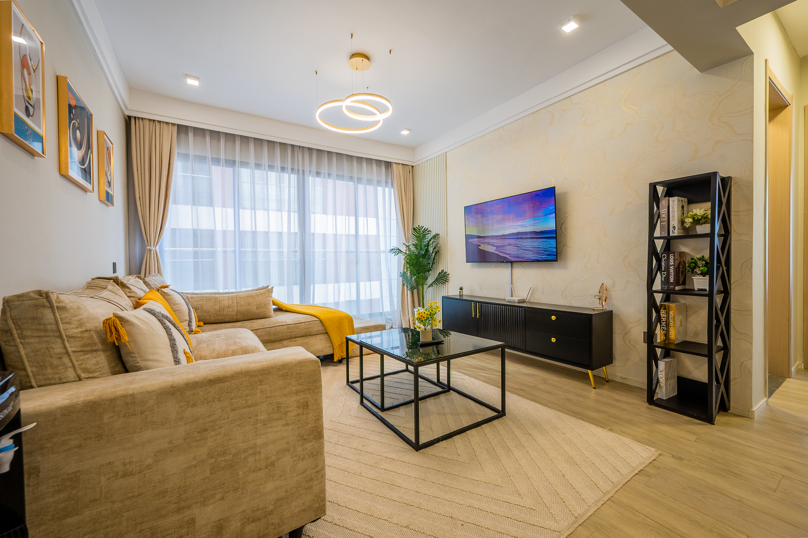 Furnished living room at Sheba Properties with sofa, coffee table and natural light